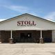 Front view of Stoll Metal Sales building with "Open" sign and clear blue sky above.