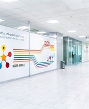 Pasillo moderno con mural colorido de huellas y líneas en una oficina de marketing digital.