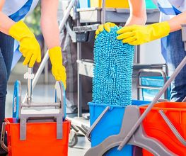 Personen mit gelben Handschuhen reinigen Böden mit Wischmopp und Wassereimern in leuchtenden Farben.