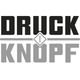 Schriftzug "DRUCKKNOPF" in zwei Farben, getrennt durch ein Symbol in der Mitte.