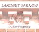 "Ziegelwand mit 'Landgut Sarnow in der Prignitz' und Pferdemotiv in der Mitte."