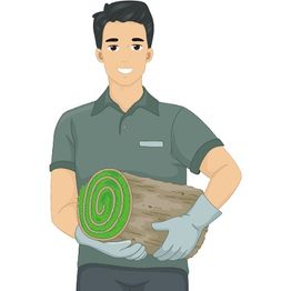 Smiling person holding a roll of sod, wearing gloves and a green shirt.