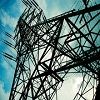 Electricity pylon with a cloudy sky background, viewed from below.