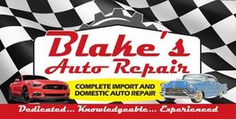 Blake's Auto Repair sign with a red car, blue car, and checkered flag background.