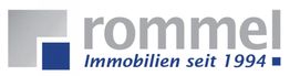 Logo mit Schriftzug: "rommel Immobilien seit 1994", graue und blaue Quadrate links.