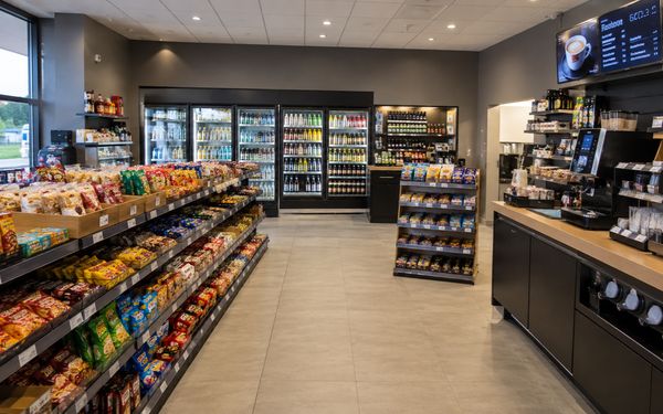 Moderner Tankstellenshop mit Snackregalen, Getränkekühlung und Kaffeestation