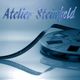 Filmrolle mit Schriftzug "Atelier Steinfeld" im blauen Farbschema.