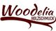 Schriftzug "Woodelia Holzschmuck" in roter, stilisierter Schrift auf weißem Hintergrund.