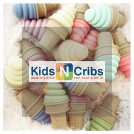 Soft, pastel-colored toy ice cream cones, overlaid with "Kids N Cribs" logo.
