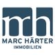 Logo von Marc Härter Immobilien in Blau auf Weiß.