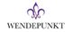 Wort "Wendepunkt" mit einer lila Lilie darüber.
