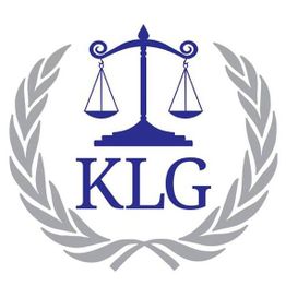 Scales of justice above "KLG" encircled by a laurel wreath.