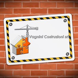 Cartello edile con grù e casa puzzle su sfondo di mattoni. Testo: "Vagnini Costruzioni srl".