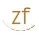 Logo mit braunen Buchstaben "zf" und einem geschwungenen Strich darunter.