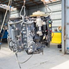 Close-up of an industrial machine part hanging in a warehouse.