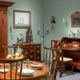 Vintage dining room with wooden furniture and decorative items.