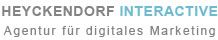 Textlogo: "Heyckendorf Interactive - Agentur für digitales Marketing" in grau und blau.