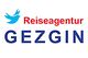 Logo der Reiseagentur Gezgin mit blauem Vogel und rotem Schriftzug auf weißem Hintergrund.