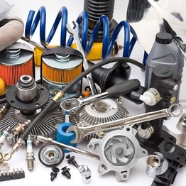 Assorted automotive parts, including filters, spark plugs, gears, and tools on a white background.