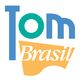 Logo colorido com texto: "Tom Brasil" em verde, azul e amarelo.