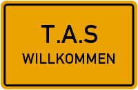 Gelbes Schild mit der Aufschrift "T.A.S WILLKOMMEN" in schwarzer Schrift.