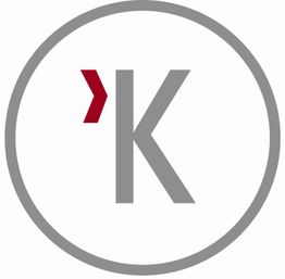 Grau-rotes "K" in Kreis auf weißem Hintergrund.