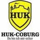 Gelbes Wappen mit der Aufschrift "HUK", darunter "HUK-COBURG" und "Da bin ich mir sicher".