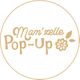 Bannière circulaire "Mam'zelle Pop-Up" avec fleur et feuilles dorées.