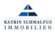 Logo von Katrin Schmalfuß Immobilien mit einem blauen, dreieckigen Symbol darüber.