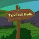 Wooden sign with "TypeTrail Media" against a grassy and rocky landscape.