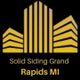 Yellow building logo with text: "Solid Siding Grand Rapids MI" on a black background.