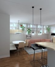 Sala moderna con cocina abierta, isla de madera, lámparas colgantes y sofá al fondo.