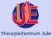 Logo des TherapieZentrum Jule, zeigt stilisiertes "J" und "E" in einem blauen Kreis.