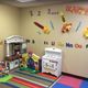 Colorful playroom with toys, alphabet wall, and a "Blast Off" space theme.