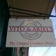 Sign for "Vito & Ariel's: The Original Carmel Pizza" hanging outside a building.