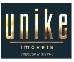 Logo da Unike Imóveis com fundo escuro e texto dourado.