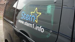 Schwarzer Van mit Aufschrift "Stern1" und Website "www.stern1.info" auf der Seitenscheibe.