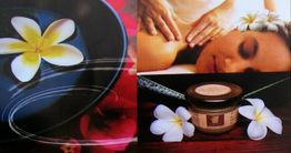 Frau erhält Massage, Blüten und Creme in Spa-Atmosphäre.