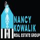 Logo of Nancy Kowalik Real Estate Group with blue house design and white text.