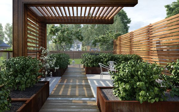 Eine moderne Sitzecke in einem Garten. Die Pflanzkübel bestehen aus Cortenstahl, darin wurden verschiedene Arten von Büschen gepflanzt.