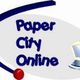 Logo mit Text "Paper City Online" und stilisiertem Computer.