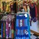 Clothing boutique with colorful dresses and skirts on display racks.