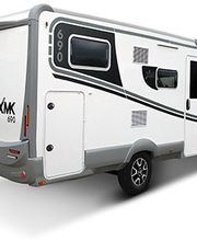 Autocaravana blanca de perfil, con ventanas y detalles negros, vista trasera.