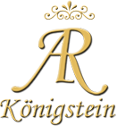 Goldenes "R" mit Krone und dem Wort "Königstein" darunter, auf schwarzem Hintergrund.