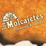 Logo of Los Molcajetes restaurant and cantina on a textured, burnt orange background.