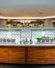 Buffet de restaurante con tazones de ensaladas y decoraciones modernas en ambiente elegante.