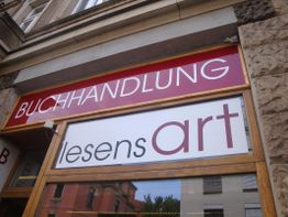 Buchhandlung mit rotem Schild "Buchhandlung lesensart" an der Fassade eines Gebäudes.