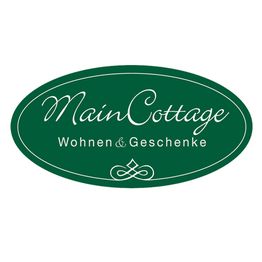Grünes Logo "MainCottage", darunter "Wohnen & Geschenke" in weißer Schrift.