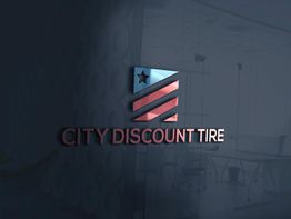 City Discount Tire logo on glass, featuring a flag design with stripes and a star.