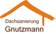 Logo: Orange Dachform mit Text "Dachsanierung Gnutzmann" darunter.